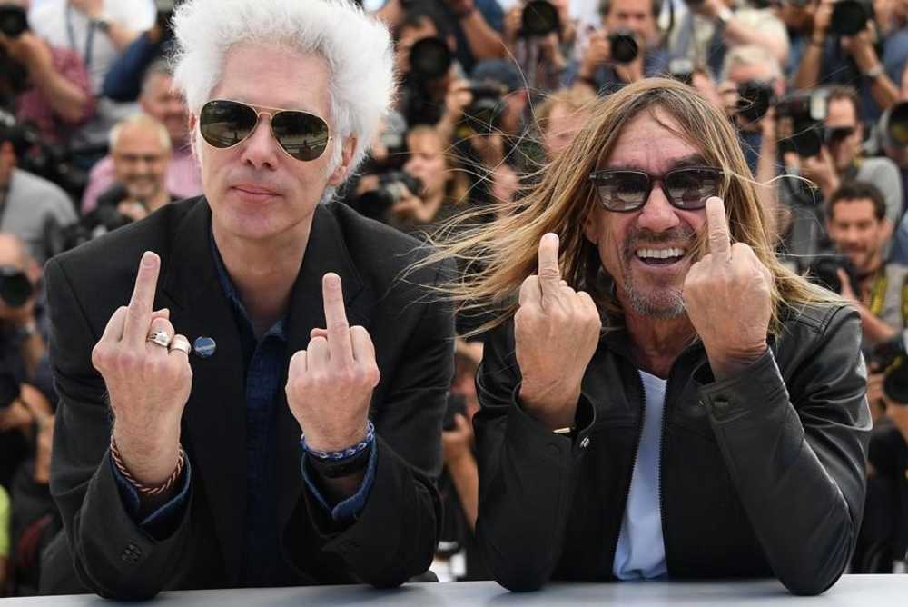 TOPSHOT - US director Jim Jarmusch  L  and US singer Iggy Pop give the fingers while posing on May 19  2016 during a photocall for the film  Gimme Danger  at the 69th Cannes Film Festival in Cannes  southern France     AFP PHOTO   ANNE-CHRISTINE POUJOULAT